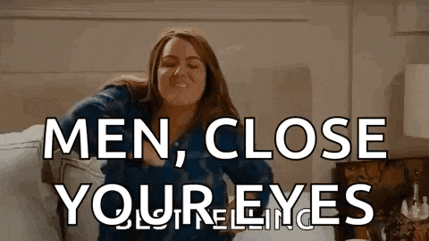 a woman is sitting on a couch with the words `` men , close your eyes '' written on the screen .