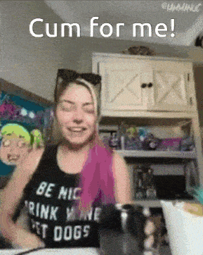 a woman wearing a tank top that says " be nice drink wine pet dogs "
