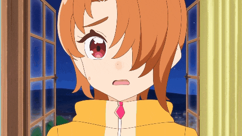 a girl with orange hair looks out a window