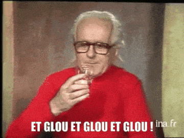 a man in a red sweater drinking from a glass with the words et glou et glou et glou written on the bottom