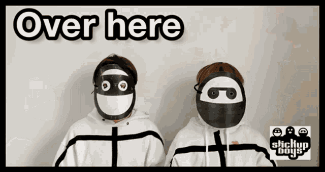 two people wearing masks with the words over here on the top