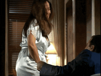a woman in a white robe is being held by a man