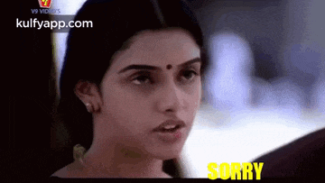 a close up of a woman 's face with the words `` sorry '' written on the bottom .