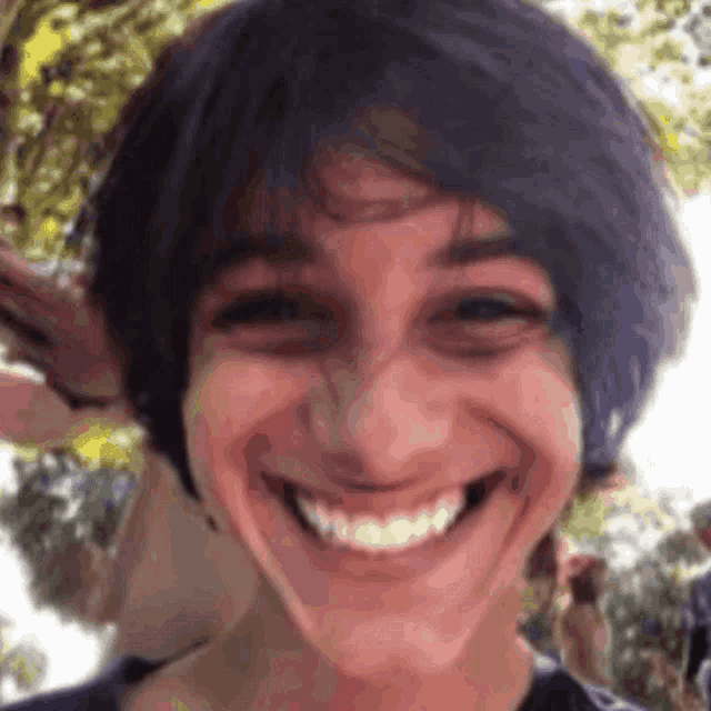 a close up of a person 's face with a smile on their face