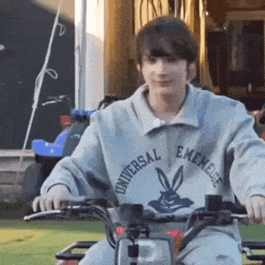 a young man is riding a motorcycle with a rabbit on the front .