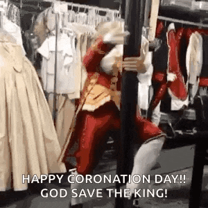a man in a red costume is standing next to a pole holding a sword .