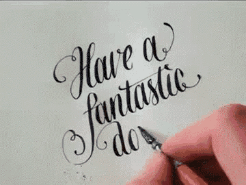 a person is writing the words `` have a fantastic day '' in calligraphy on a piece of paper .