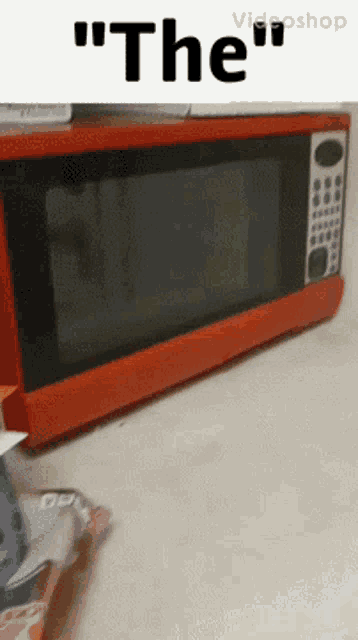 a red microwave with the word " the " on the top