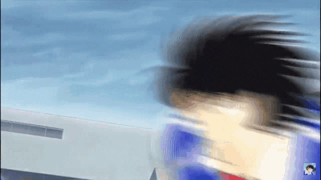 a blurry picture of a person running with a blue sky in the background .
