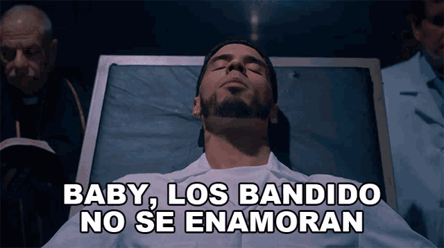 a man laying in a hospital bed with the words baby los bandido no se enamoran written above him