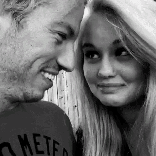 a man and a woman are looking into each other 's eyes .