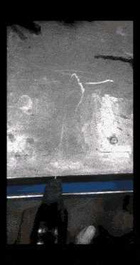 a person using a drill on a piece of metal