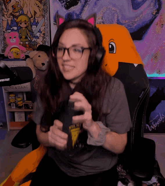 a woman wearing headphones sits in front of a microphone with a sign that says woods on it