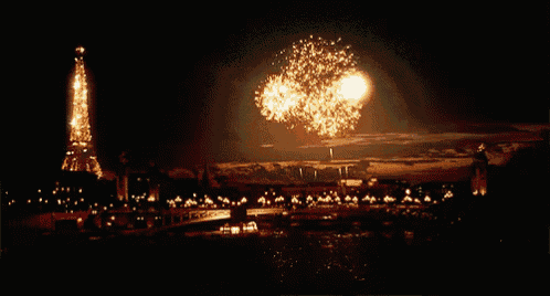 the eiffel tower is lit up with fireworks in the night sky
