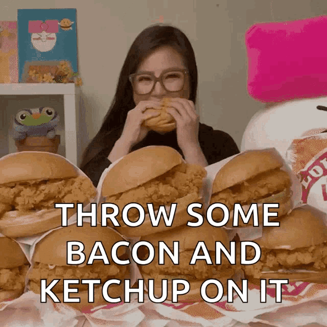 a woman eating a chicken sandwich with the words throw some bacon and ketchup on it below her
