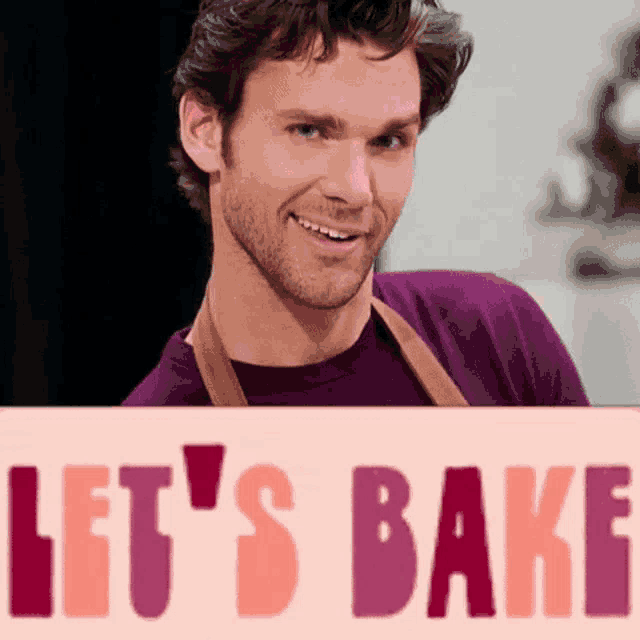 a man holding a sign that says let 's bake on it