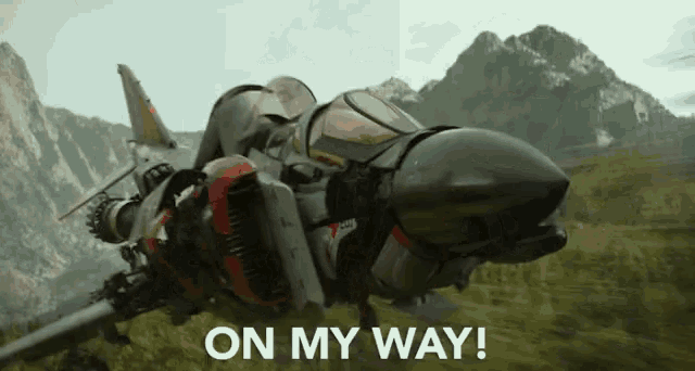 a fighter jet is flying over a grassy field with the words `` on my way '' written on the bottom .