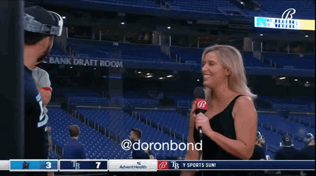a man wearing a watermelon shirt is being interviewed by a woman with a microphone