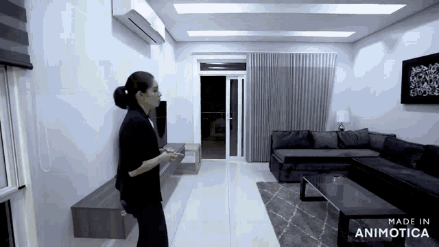 a woman is standing in a living room with the words made in animatica on the bottom