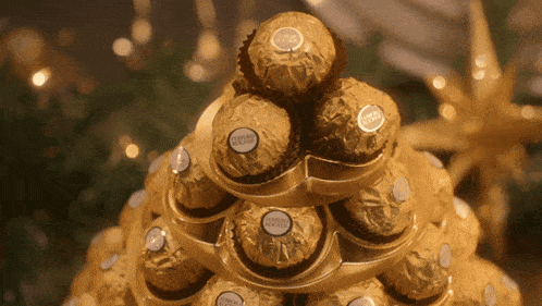 a stack of ferrero rocher chocolates in gold wrappers