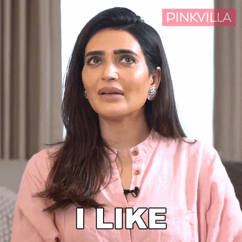 a woman in a pink shirt says i like in white letters