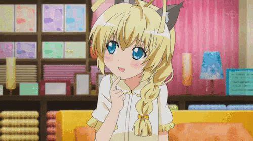 a girl with blonde hair and blue eyes is sitting on a yellow couch