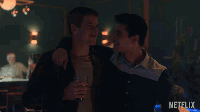 two men standing next to each other with a netflix logo on the bottom