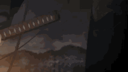 a close up of a person holding a sword in their hand .