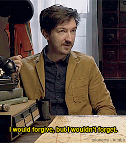 a man sitting at a table with the words i would forgive but i would n't forget