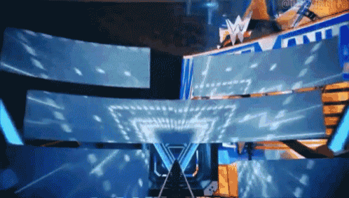 a large screen with the letter w on it is projected on a stage