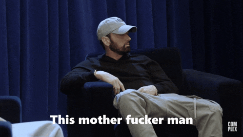 a man sitting in a chair with the words this mother fucker man written on the screen