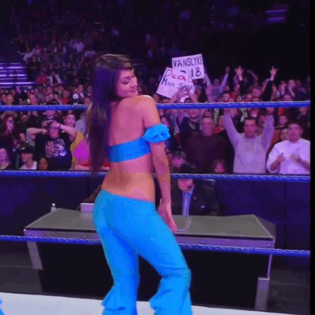 a woman in a blue outfit is holding a sign that says vanslyne
