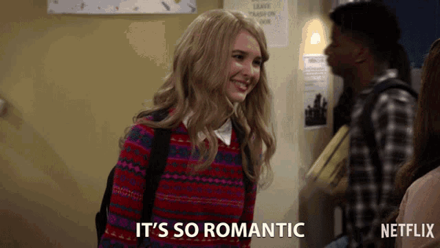 a girl in a red sweater is smiling and says it 's so romantic