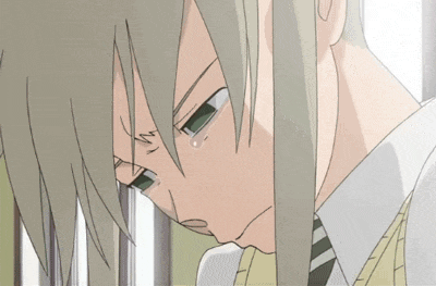 a close up of a person 's face with a tear running down their cheek