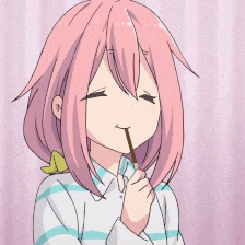 a girl with pink hair is eating a candy bar