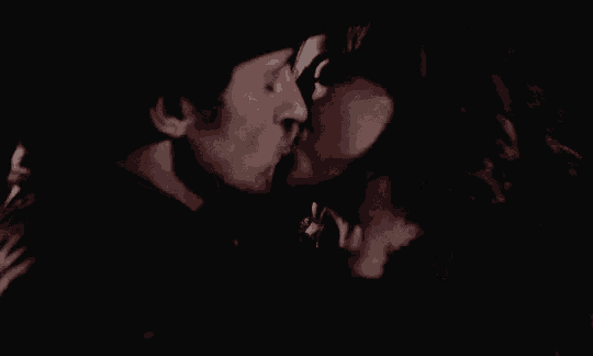 a man and a woman face to face in the dark