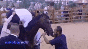 a man is petting a horse in a fenced in area with the hashtag eskobaredit