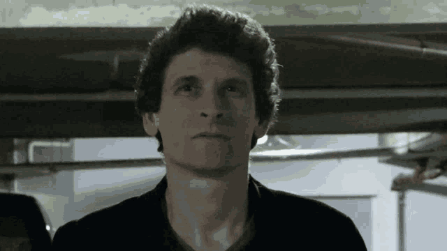 a close up of a man 's face with a serious look on his face