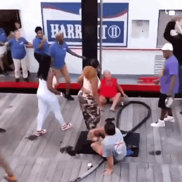a group of people are dancing in front of a harr sign