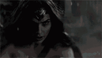 a close up of a woman wearing a headband and a sword .
