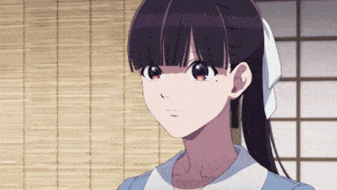 a close up of a girl 's face with a bow in her hair