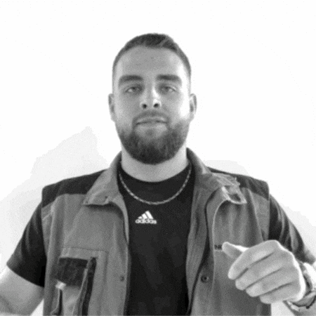 a man with a beard is wearing an adidas vest
