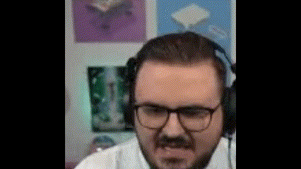 a man with a beard wearing headphones and glasses is making a funny face .