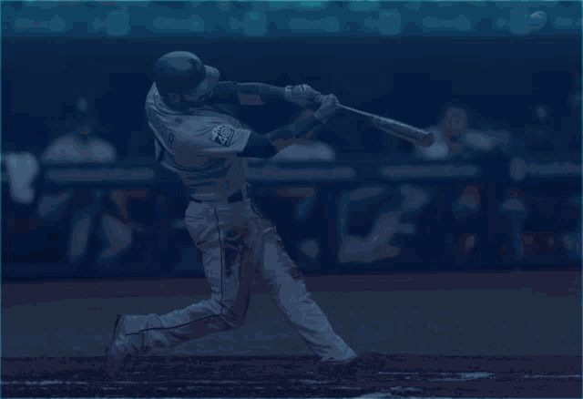 a baseball player swings at a ball and the word gone is above him