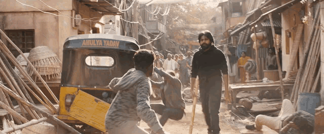 a yellow rickshaw that says ' amulya yadav ' on the side