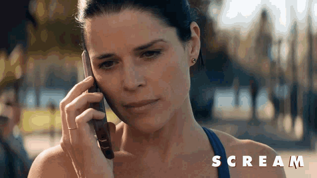 a woman is talking on a cell phone and the word scream is on the bottom right