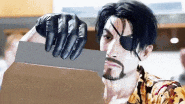 a man with a beard and an eye patch is holding a large knife in his hand .