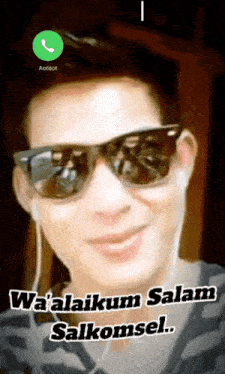a picture of a man wearing sunglasses and ear buds with the words wa'alaikum salam salkomsel