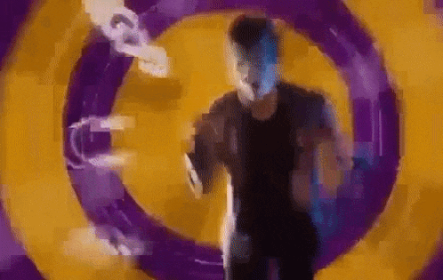 a man is running through a purple and yellow circle in a video game .