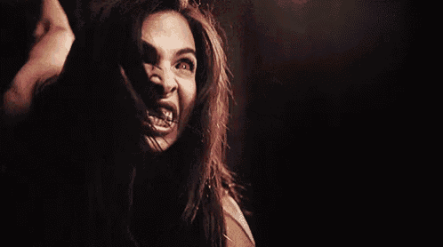 a woman with braces on her teeth is making a funny face .